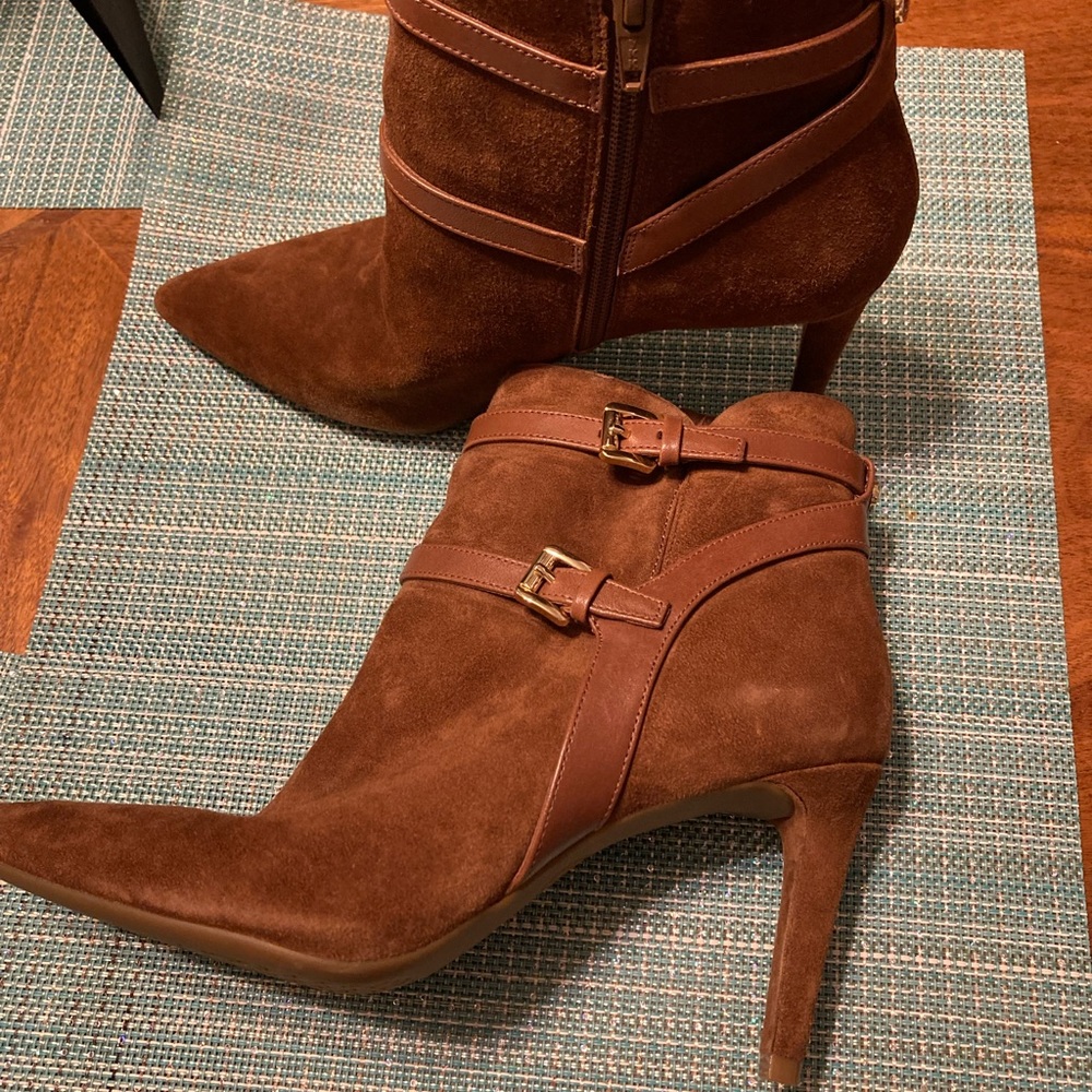 Women’s brown Michael Kors booties with a 3.25 inch heel.